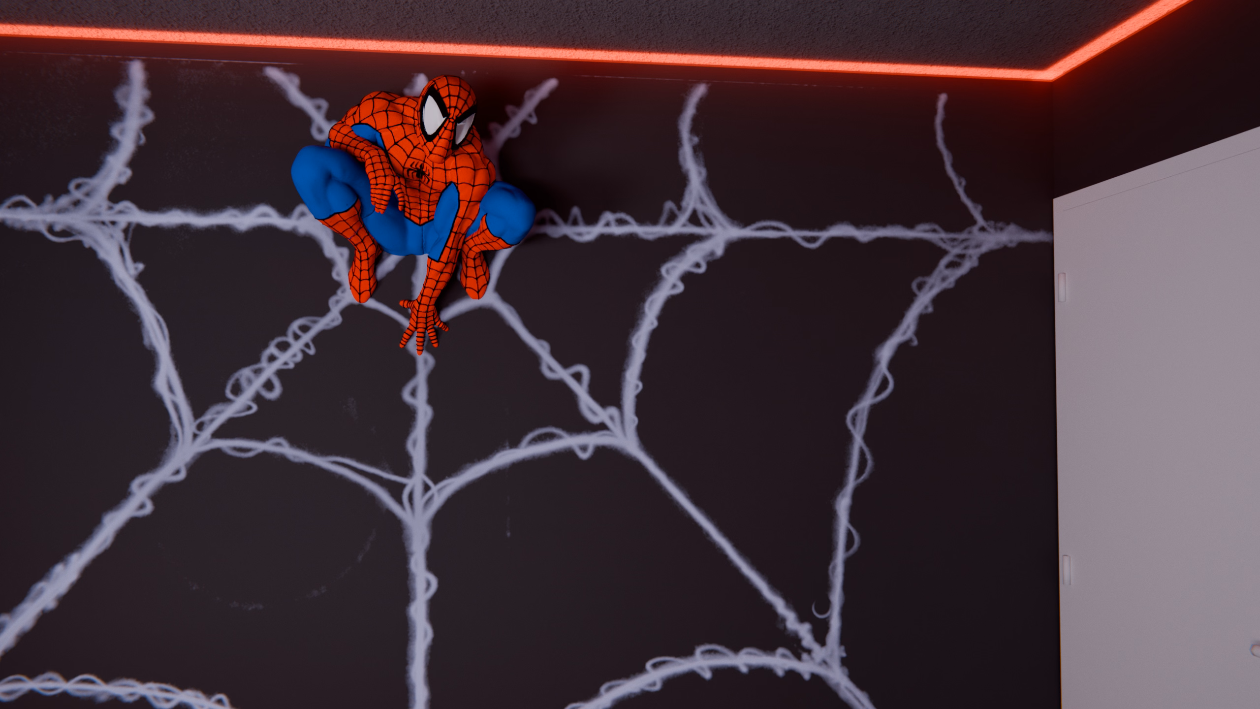 A Spider-Man figure perched on an airbrushed spider-web mural that spans the back wall of the lab.